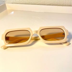 Cream sunglasses with warm lenses